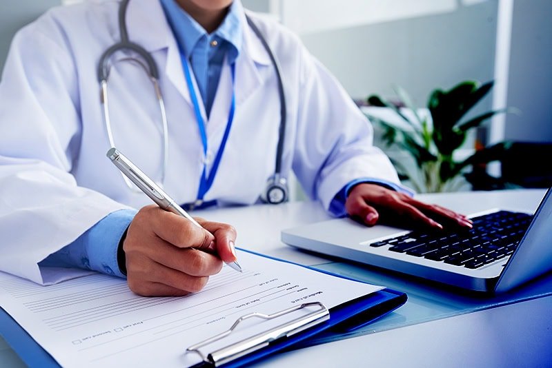 hands-unrecognizable-female-doctor-writing-form-typing-laptop-keyboard copy hands-unrecognizable-female-doctor-writing-form-typing-laptop-keyboard copy